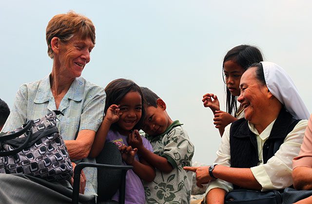 Nuns share a light moment with the children of sitio San Roque in North Triangle, Quezon City a few days after the demolition. (Photo by Ronalyn V. Olea/ Bulatlat.com)