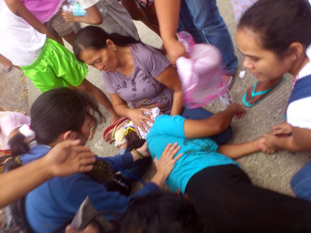 Urban poor leader Estrelieta Bagasbas loses consciousness in a scuffle during the demolition. (Photo by J. Ellao / Bulatlat.com)