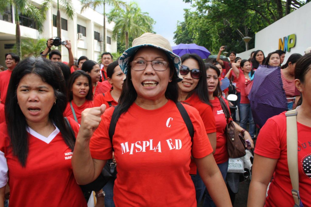NXP workers join caravan from NXP in industrial economic zone in Laguna to labor dept. headquarters in Manila. They press for completion of CBA talks and reinstatement of 24 union officers. (Bulatlat File Photo, June 2014)