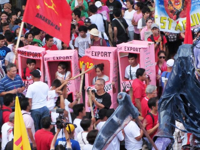 May 1 marchers depict the 'deadly' impact of what they call as cheap labor and labor export policies of the Ph government (Photo by M. Salamat / Bulatlat.com)
