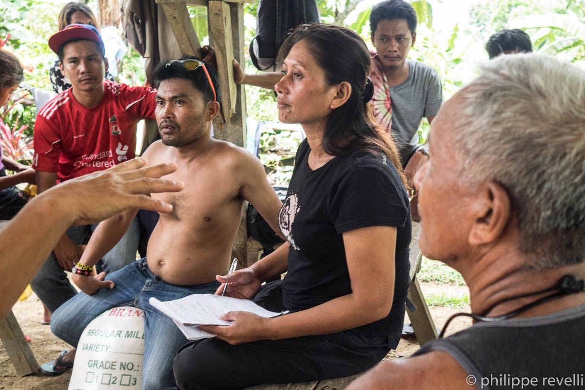 Aida Seisa, center, in a fact-finding mission two weeks before her house was strafed in June. (Photo by P. Revelli/philipperevelli.com)