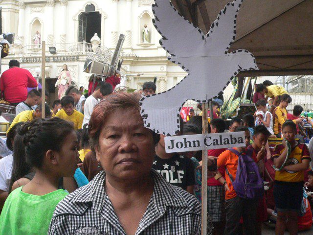 Ligaya Portajada, whose husband Armando was disappeared in 1987, holds a "dove" for the latest missing victim (Photo by D.Ayroso/Bulatlat.com)