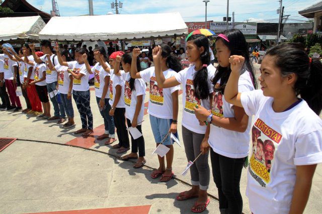 Alcadev students raise their fists to salute their school director, “Sir Emok” and vowed to continue what he has started for the education of the Lumads in Surigao del Sur.