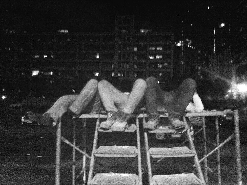 Construction workers take a nap in the middle of their night shift. Behind them are office and apartment buildings none of them would ever sleep in. (Ortigas Center, Pasig City)
