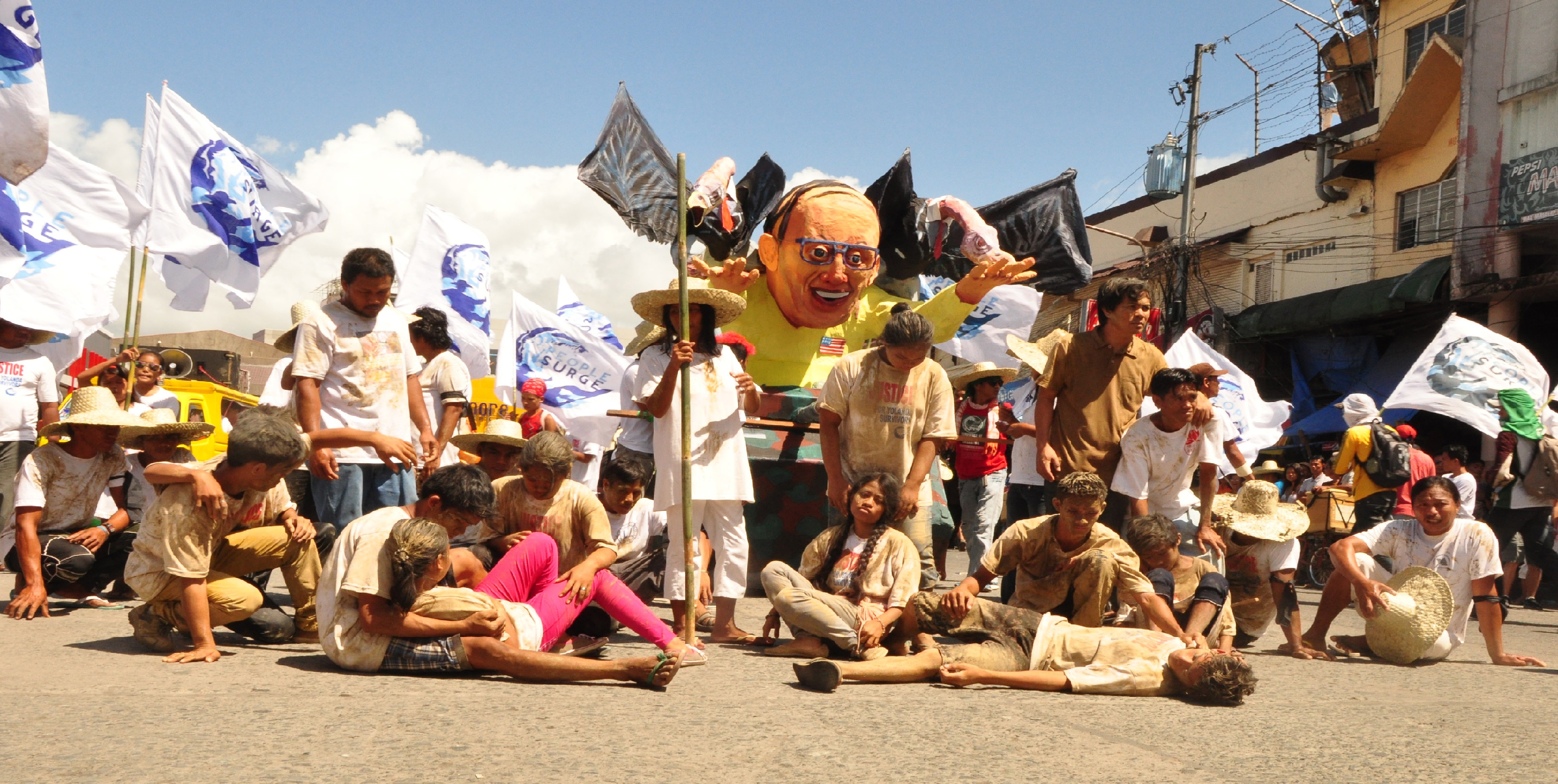 Typhoon Yolanda (Haiyan) survivors dramatize their plight during the massive survivors’ march to commemorate the first anniversary of the world’s most powerful typhoon ever to make landfall. (Photo by H.Gasmen/Bulatlat.com)