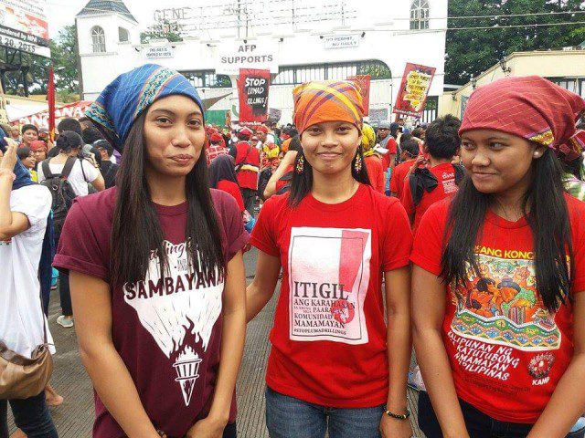 (FILE PHOTO) BLOOMING IN ADVERSITY. Danah Marie Marcellana (on the right), with sister Ara (left) and Lumad activist Michelle Camposin a protest in front of Camp Aguinaldo in 2015 (Contributed photo/Bulatlat.com)