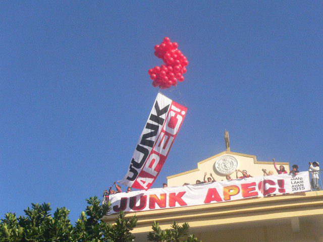 Dozens of red balloons carried afloat a "Junk Apec" sign from atop the Baclaran bell tower (Photo by D.Ayroso/Bulatlat.com)