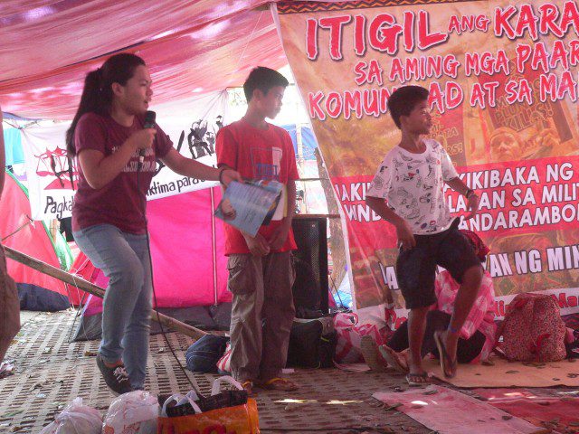 Rerie Ratilla of Anakbayan UP reads the story "Birang," with participation from Misfi students (Photo by D.Ayroso/Bulatlat.com)