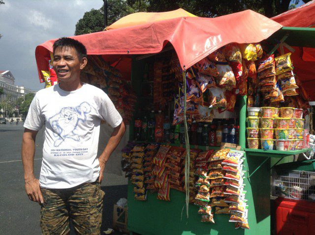 Luneta vendor says the closest they can get to the popular grocery chain ins the fact that his store is painted green. (Photo by J. Ellao / Bulatlat.com)