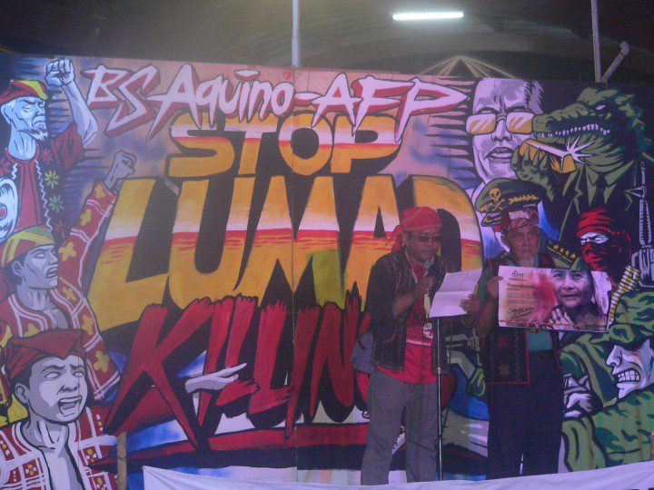 GRATEFUL. Kerlan Fanagel, (left) chairperson of Pasaka and Sulong Katribu partylist 3rd nominee, reads a list of groups and personalities that supported Manilakbayan, at the send-off solidarity night on Nov. 20. Beside him is Matanem Monico Cayog, chairperson of Kalumaran. (Photo by D.Ayroso/Bulatlat.com)