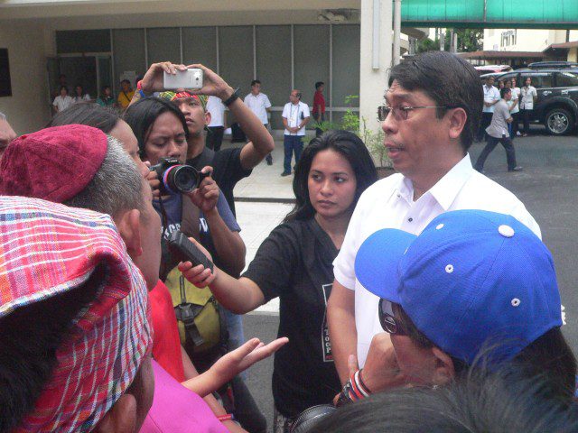 MGB Director Leo Jasareno (right, in white) talks to the protesters. (Photo by D.Ayroso/Bulatlat.com)
