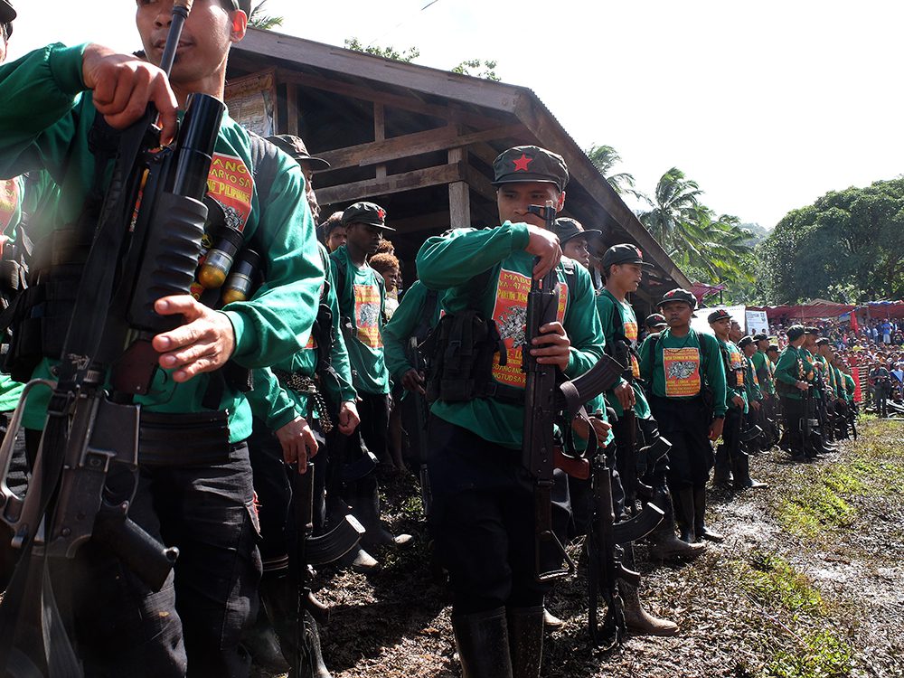 A company of New People's Army guerillas gets ready to start the Communist Party of the Philippines' 47th anniversary program after leading the singing of the communist hymn "Ang Internasyunal." (Kitcharao, Agusan del Norte)