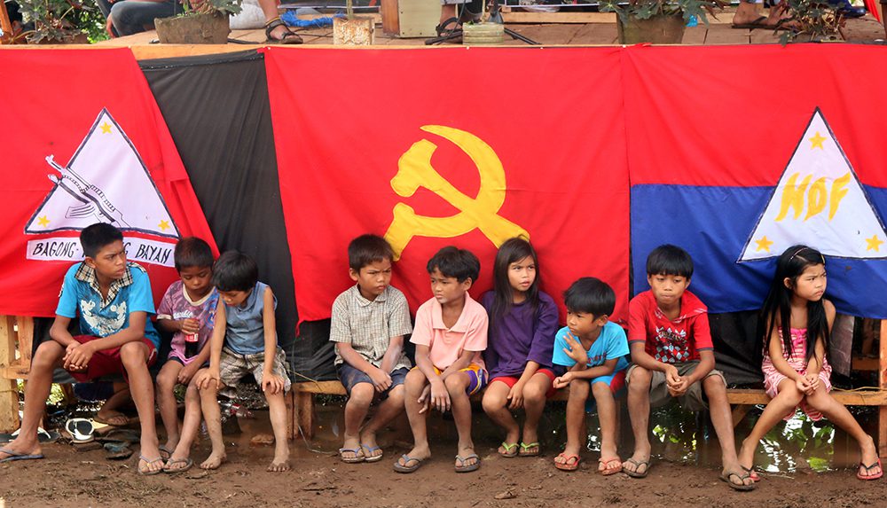 Young residents patiently wait for the start of the CPP anniversary celebrations their community hosted last December. (Kitcharao, Agusan del Norte)