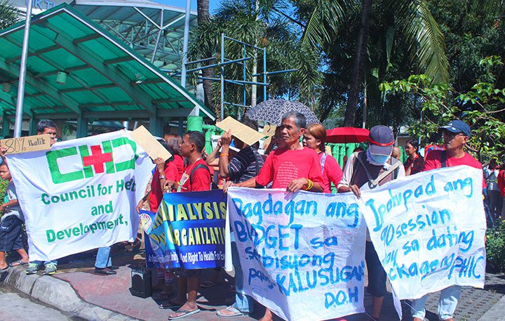 Poor patients hold a protest action in front of the National Kidney Transplant Institute (NKTI) condemning the removal of 80-percent discount for charity patients, Feb. 12. (Photo by Ronalyn V. Olea / Bulatlat)