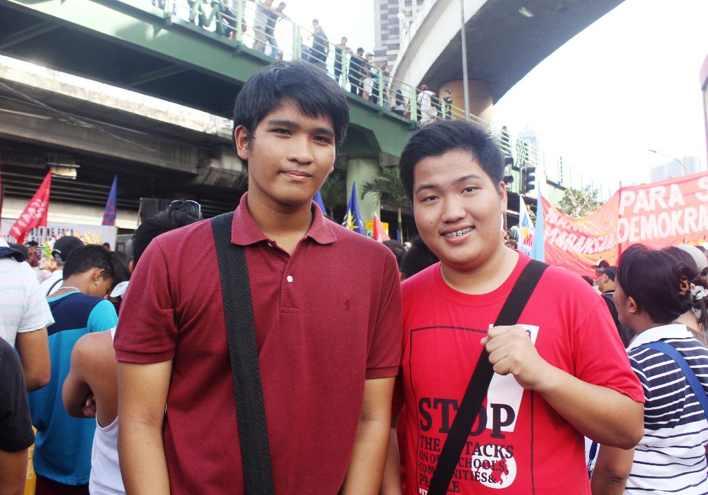Mark Santos, 15 (left), and his friend Lorenz Martin Godoy, 17 (right), both from Cavite in the 30th commemoration of the 1986 people power uprising. (Photo by Anne Marxze D. Umil/ Bulatlat)