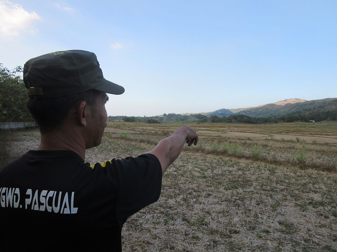 Jimmy Pascual points to the site of the solar project in Macabud village. (Photo by Miko Mendizabal / Bulatlat)