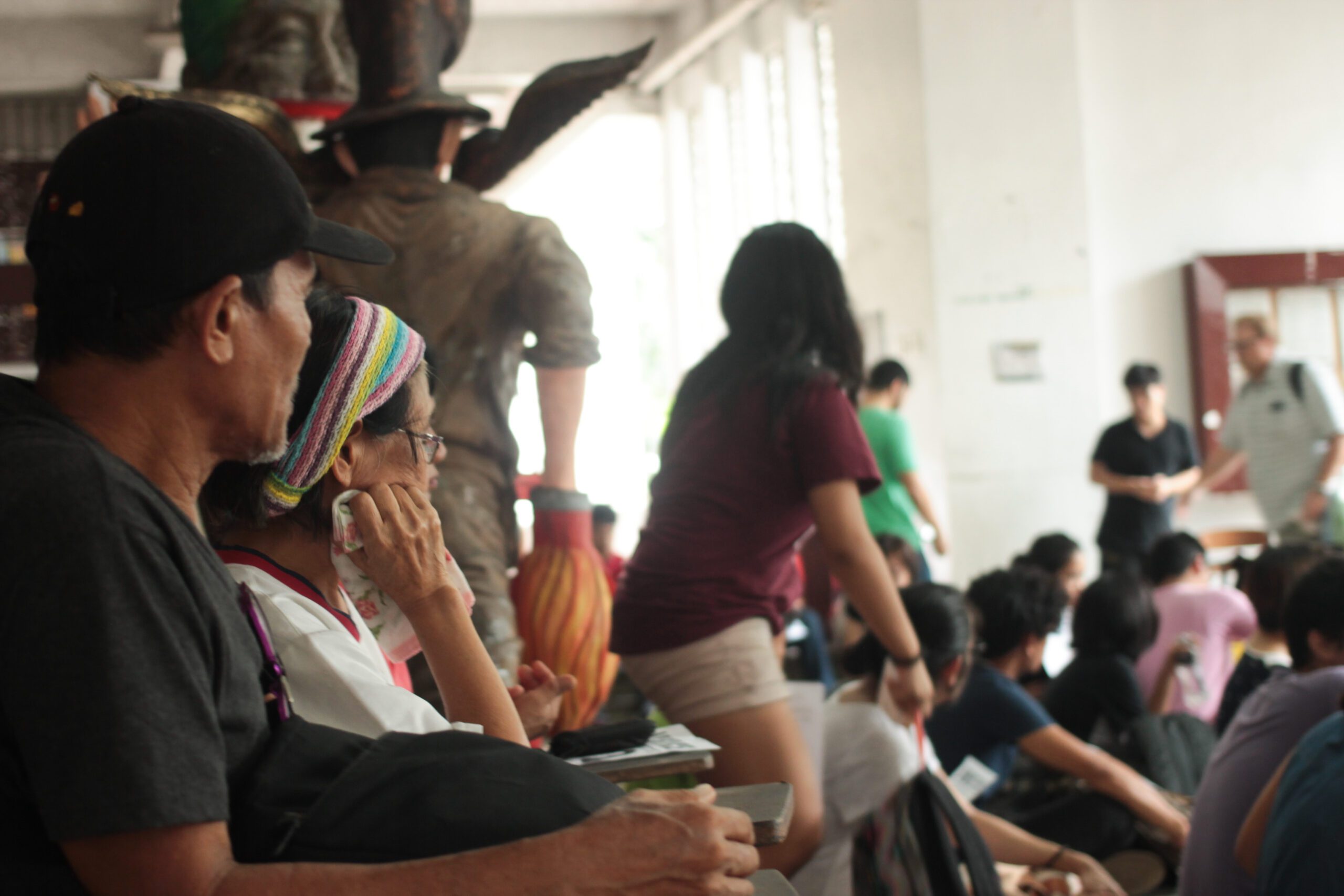 Asher and Linda Cadapan (foreground) look on during the program at Palma Hall lobby (Photo by G.Estella/Bulatlat)