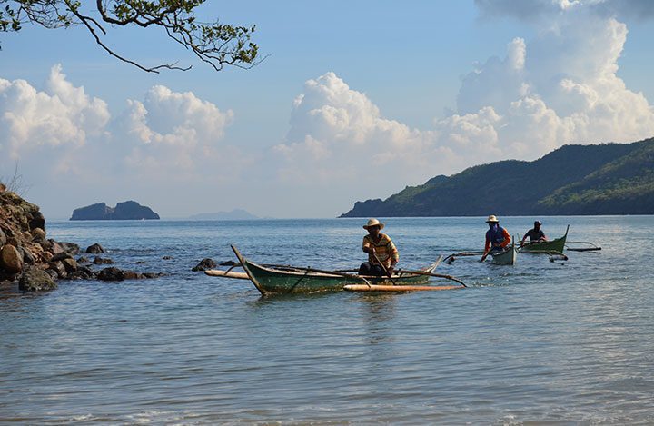 Fishermen coming back from an early morning fishing trip. Ninety percent of the community in barangay Sta Mercedes, Maragondon, Cavite are fishermen. The coveted Patungan Cove faces the famous Corregidor and Carabao Islands of Bataan province in the south. (Photo by Jen Guste / Bulatlat)