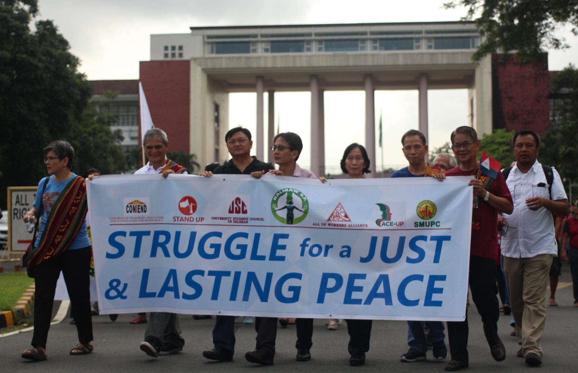 L-R: Dr. Carol Araullo of Bayan. NDFP peace consultant Jaime Soledad, UP Vice Chancellor for Community Affairs Nestor Castro and Chancellor Michael Tan, Wilma and Benito Tiamzon, Rafael Baylosis, Randy Malayao, join in the march towards the Diliman Commune marker (Photo by Gino Estella/Bulatlat)