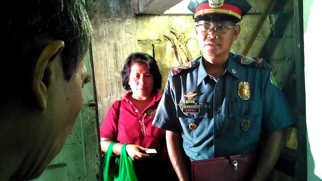 A police man visited Raymark Sumalbag at his home (Photo by JR Burgos/Pinoy Weekly)