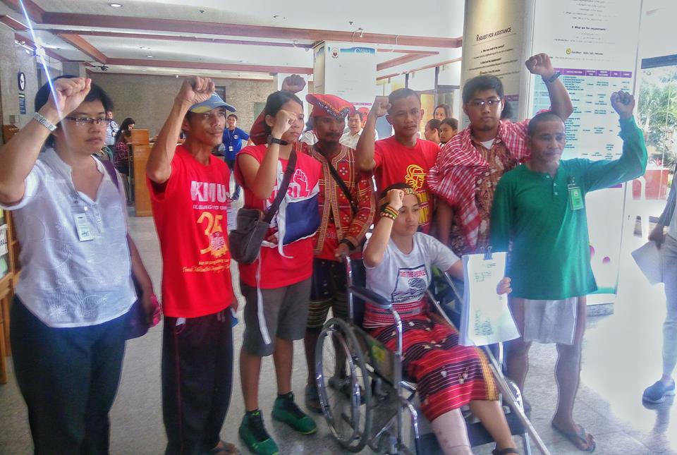 'NOW WE MAKE THEM PAY.' (L-R) Dr. Julie Caguiat, Reyan Naong, Nicole Soria, a Manobo datu, Dionesio Abear, Jerome Aba, Reynaldo Moldon, and Piya Macliing Malayao (in wheelchair). Except for Aba and the Manobo datu, the six are among the nine activists who charged the Manila Police with attempted murder and other criminal and administrative cases at the Ombudsman, Oct. 26. (Photo by Kilab Multimedia)