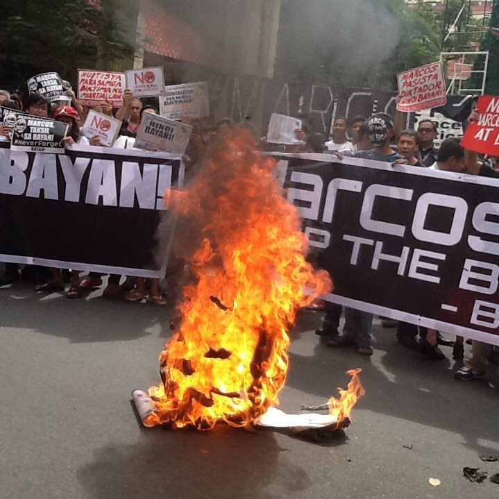Activists burn ousted Dictator Marcos "head" at the end of the protest in front of UP-PGH along Taft avenue, Manila. Photo by Dee Ayroso/Bulatlat)