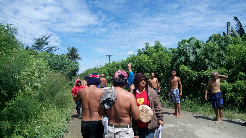 The men took off their shirts to show they are civilians and are not armed. (Photo by Kilab Multimedia)