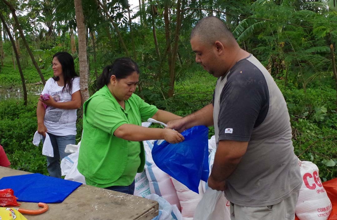 Rogina Quilop (in green vest and polo) repacks relief good for victims of Haiyan last year. (Photo courtesy of CPRS)