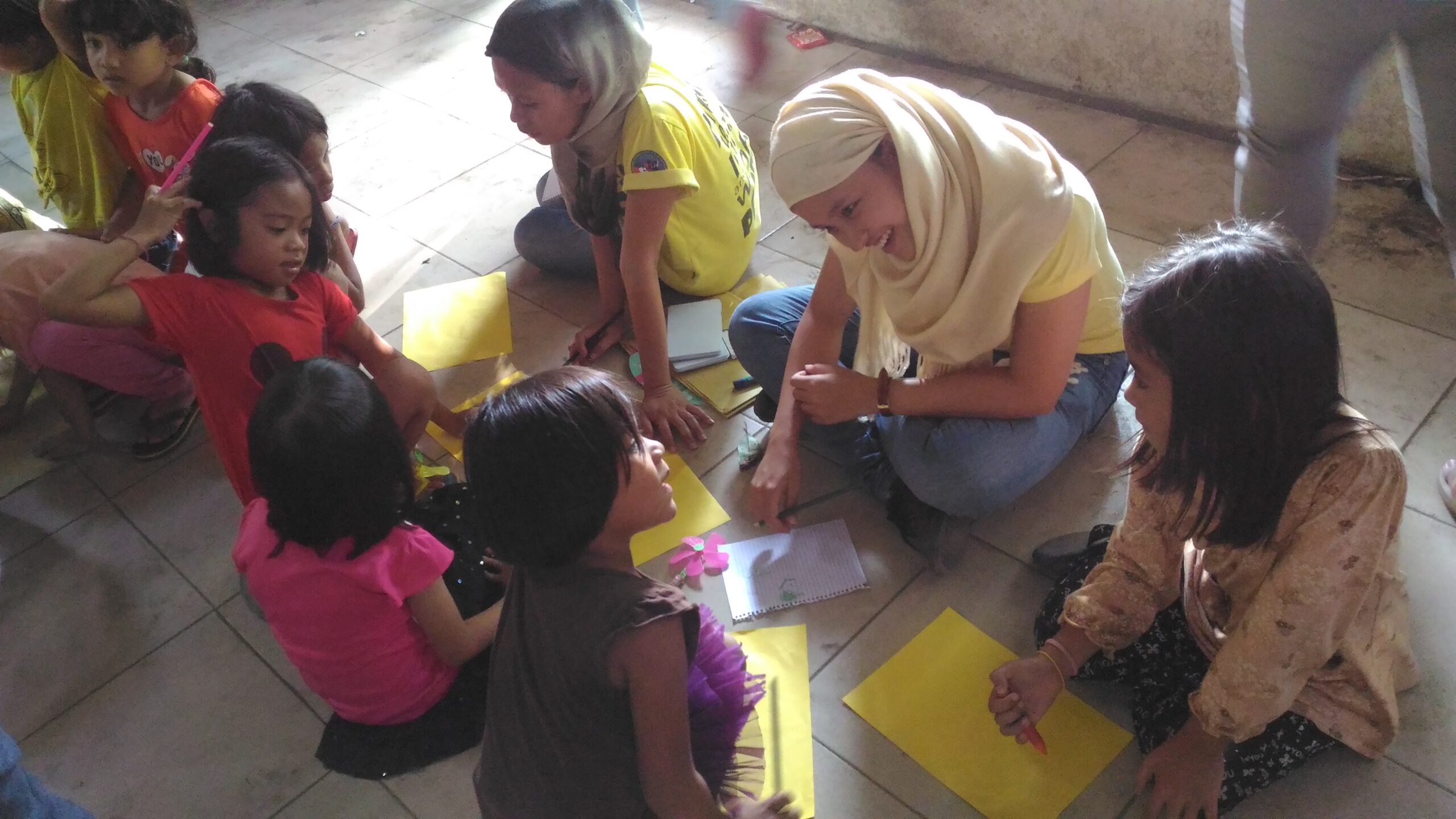 A delegate of the NIHM facilitates a drawing workshop for children evacuees (Contributed photo)