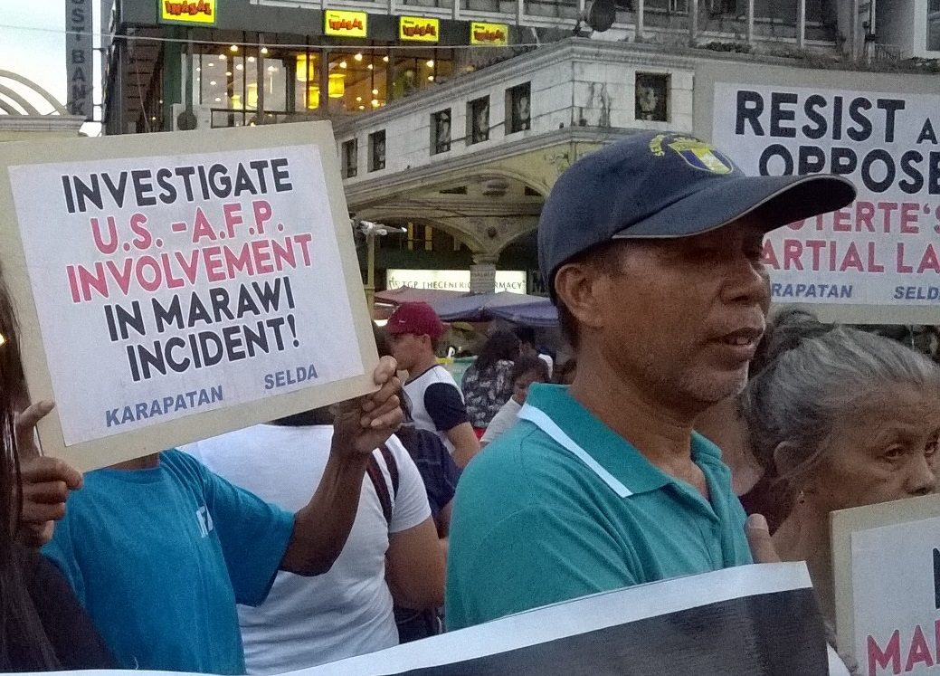 Jose Ceriales (in bull cap) at joins the protest against martial law in Mindanao at Plaza Miranda on May 24 (Photo by Dee Ayroso/Bulatlat)