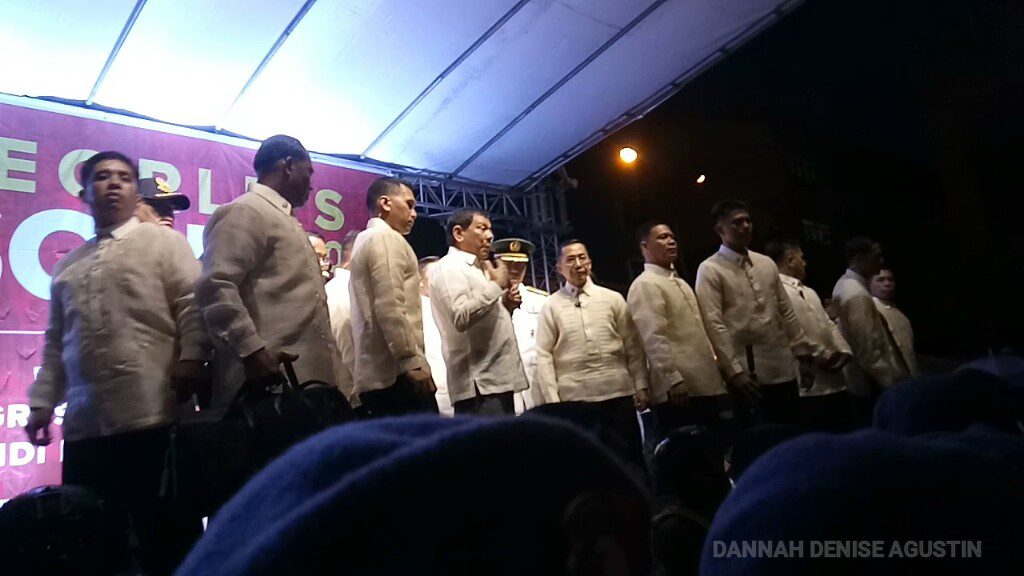 President Duterte on the stage of the People's SONA rally. On the stage with him are PSG men, while below stand a SWAT team, more PSG men, and on the outer ring, police women facing protesters. (Photo by Dannah Denise Agustin/Bulatlat)