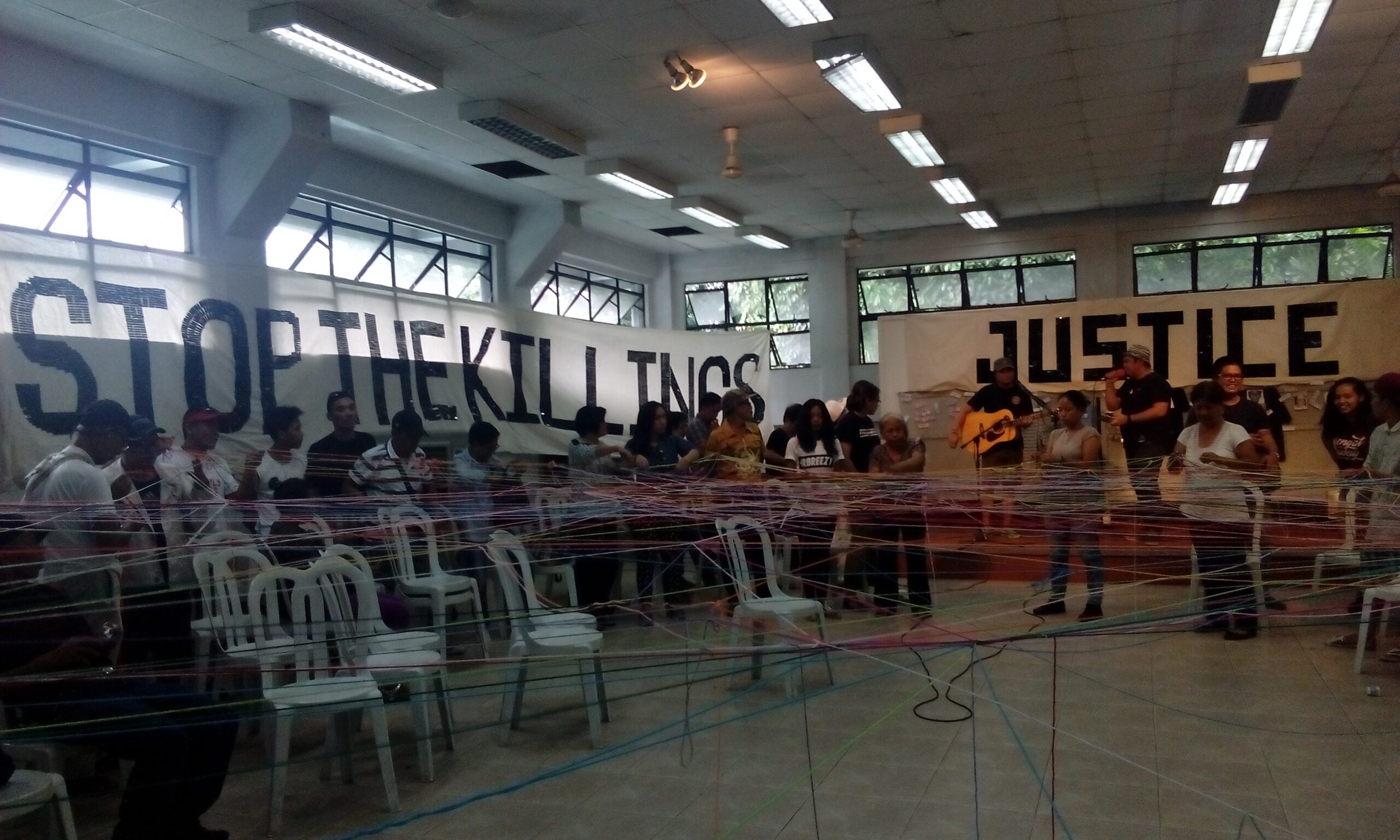 WEB OF LIFE. Former political prisoners, families of victims of enforced disappearance and political and drug-related killings 'spun' a web with colored yarn to symbolize their connection and united call for justice (Photo by Alab Mirasol Ayroso/Bulatlat)