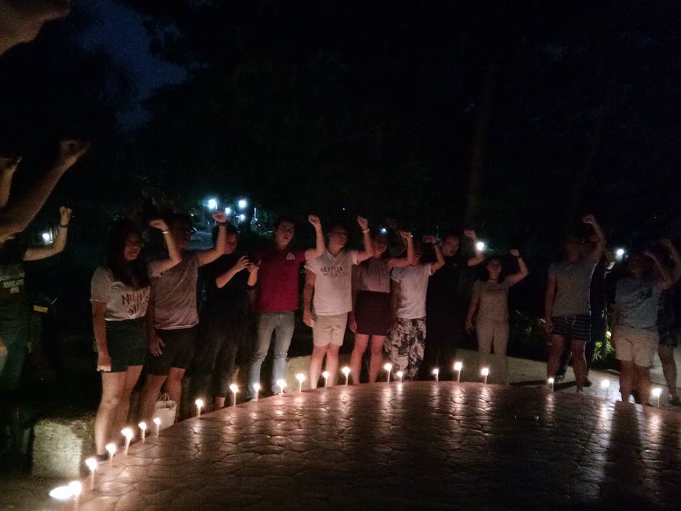 Students of the University of the Philippines-Diliman lit candles at the Dap-ayan, College of Mass Communications, to give tribute to Karen Empeno and Sherlyn Cadapan on June 26, on the 11th year of their disappearance (Photo by Daniel Boone/Bulatlat)